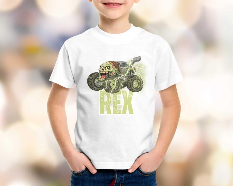 May include: White t-shirt featuring a cartoon monster truck with a zombie driver, green and gray color scheme, and the name "REX" in green block letters. The truck has large tires and lightning bolts.