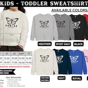 May include: A cream toddler sweatshirt featuring a butterfly design and the text "PARLAY APPAREL." Available in various colours, such as heather grey, black, and red. Sizes from 2T to 7T, with widths from 33.02 to 39.37 cm and lengths from 38.10 to 48.26 cm.