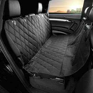 May include: Black quilted car seat cover with a hammock style extension for the back seat. The cover is designed to protect the seats from dirt, hair, and scratches.