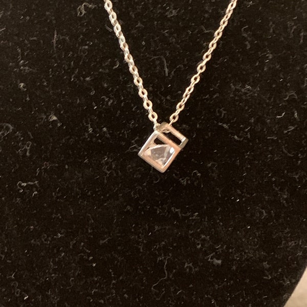 A modern glam, sleek metal box necklace with a diamond surprise!