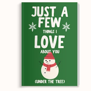 May include: A green Christmas-themed notebook with the text "JUST A FEW THINGS I LOVE ABOUT YOU" in white. A snowman illustration with a red hat and scarf is featured below the text. The phrase "(UNDER THE TREE)" is at the bottom.