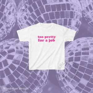 May include: White t-shirt with the text "too pretty for a job" in pink letters.