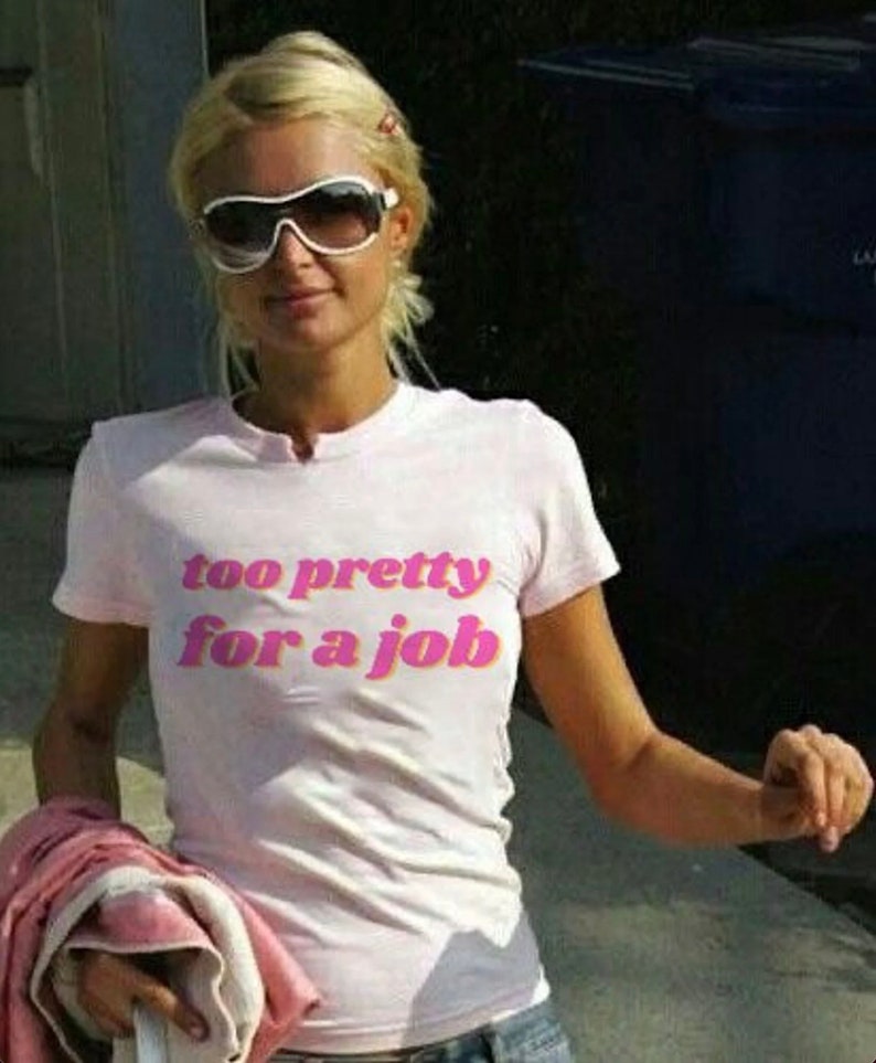 May include: A pink t-shirt with the text "too pretty for a job" in pink and orange letters.
