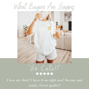 May include: White t-shirt with a yellow and orange sun graphic. The shirt is paired with gray shorts. The image includes the text "What Buyers Are Saying:" and "So Cute!!" with a five-star rating.