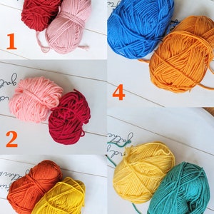 May include: Ten balls of yarn in various colors, including red, pink, blue, orange, yellow, and green. The balls of yarn are arranged in pairs, with each pair numbered 1 through 5.