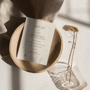 May include: A white card with a handwritten menu for a meal. The menu includes appetizers, main courses, and dessert. The text on the card reads "Let's Eat".