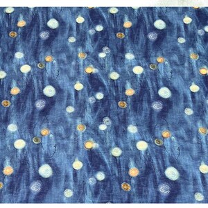 May include: A blue fabric with a pattern of white and yellow floral designs. The flowers have a circular shape and are scattered across the fabric. The background has a watercolor effect.