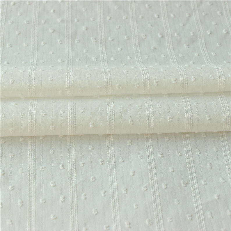 May include: White cotton fabric with a small dot pattern and vertical stripes. The fabric is folded in thirds.