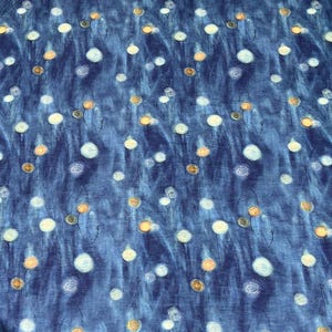 May include: A fabric with a dark blue background featuring a pattern of white and gold floral designs. The flowers are scattered across the fabric, with thin black stems. The overall effect is a soft, watercolor-like appearance.