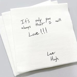 May include: A stack of white paper napkins with handwritten black ink text. The text reads "It's only you that I will always Love !!!" and "Love Hugh".