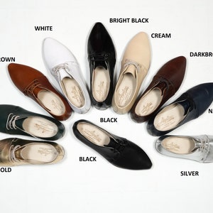 May include: A variety of pointed-toe leather shoes in different colors, including black, white, brown, green, gold, silver, cream, navy blue, and dark brown. The shoes are arranged in a circle on a white background.