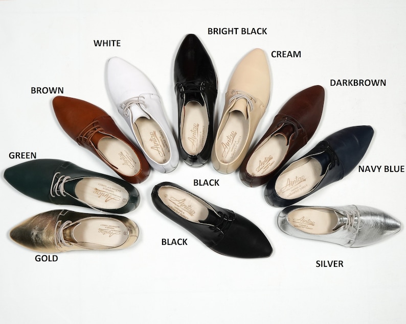 May include: A variety of pointed-toe leather shoes in different colors, including black, white, brown, green, gold, silver, cream, navy blue, and dark brown. The shoes are arranged in a circle on a white background.