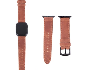 May include: Two brown leather watch straps with black buckles. The strap on the left is attached to a black watch face.