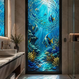May include: A tall, rectangular glass door featuring a vibrant underwater scene with a school of blue and yellow angelfish swimming near a coral reef. The artwork displays deep blue water, sunlight filtering from above, and textured coral formations.