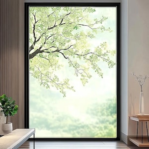 Puede incluir: Una ventana enmarcada con una escena de la naturaleza. La imagen presenta un árbol con hojas y ramas verdes contra un cielo suave y nublado. El marco es negro, creando una atmósfera serena y relajante.