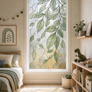 May include: A window film featuring a stained glass design with green leaves and organic shapes. The pattern displays a botanical motif with translucent textures, creating a decorative privacy screen that filters light through the glass pane.