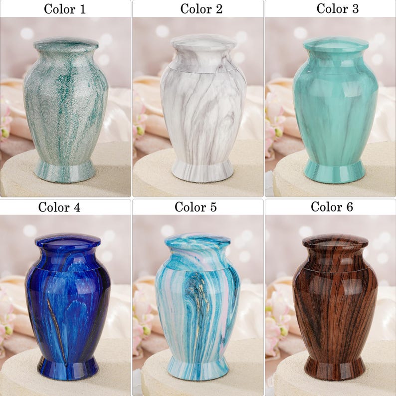 May include: A collection of six decorative urns, each featuring a distinct finish: a textured green, a white marble pattern, a solid teal, a deep blue with gold accents, a light blue and white swirl, and a dark brown wood grain pattern.