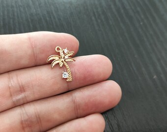 May include: Gold palm tree charm with clear rhinestone accents. The charm is perfect for jewelry making or crafting.