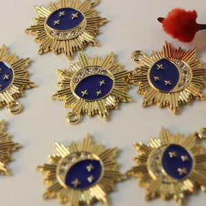 May include: Gold-toned metal charms with a blue enamel crescent moon and stars design. Each charm has a loop for attaching to jewelry or other crafts.