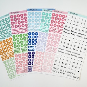 May include: A set of colorful sticker sheets with numbers 1-31 and days of the week. The stickers are in various colors, including pink, blue, green, and orange. The stickers are perfect for planners, journals, and other paper crafts.