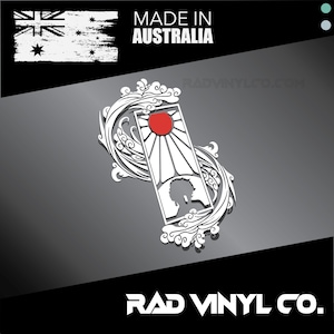 May include: White vinyl sticker with a stylized Japanese wave design and a red sun. The sticker also features a silhouette of a person's head. The text "MADE IN AUSTRALIA" and "RAD VINYL CO." are also included.