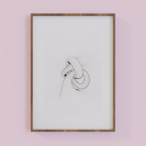 May include: A framed print of a white abstract design with a 3D effect. The design is a series of overlapping circles and lines, creating a sense of movement and depth. The print is framed in a simple wooden frame.