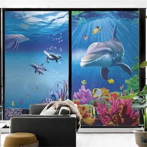 May include: A colorful underwater scene with two dolphins, sea turtles, and coral reefs. The scene is depicted on a window film, which is a great way to add privacy and style to your home.