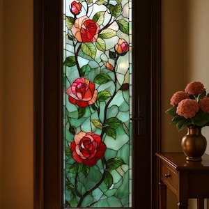 May include: A stained glass door panel with a design of red roses, green leaves, and buds on a light green background. The door is framed in dark brown wood. A small wooden table with a vase of flowers is to the right.