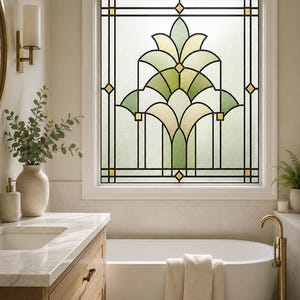 May include: A rectangular window film featuring a stained glass pattern with black lead lines, light green and cream-coloured segments, and small yellow diamond accents. The design displays a symmetrical, stylised floral motif.
