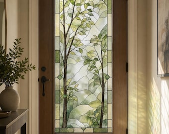 May include: A dark brown wooden door featuring a tall, rectangular stained glass insert. The glass panel displays a nature-inspired design with two slender trees, green leaves, and branches rendered in various shades of green and clear glass.