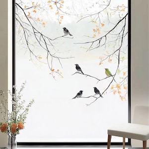 May include: A window with a frosted glass film featuring a black and white silhouette of a tree branch with birds. The birds are perched on the branches and have a watercolor effect. The background is white.