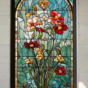 May include: A stained glass window with a floral design. The window features a variety of flowers in shades of red, pink, yellow, and orange. The flowers are arranged in a cluster and are surrounded by green leaves. The background of the window is a light blue color.