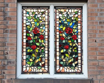 May include: A stained glass window featuring a floral design with red roses, green leaves, and a mosaic background.