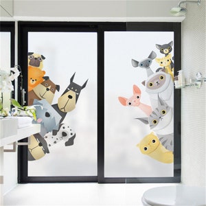May include: A frosted glass shower door with a decorative film featuring cartoon dogs and cats peeking out from behind the glass. The dogs are brown, black, white, and gray, while the cats are gray, white, and orange.