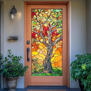 May include: A wooden front door with a stained glass window featuring a tree design. The stained glass uses a mosaic of colors, including red, orange, yellow, and green, to depict the tree and its foliage. The door is framed in light brown wood.