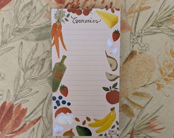 May include: A notepad with the word "Groceries" in cursive script at the top. The notepad is decorated with illustrations of carrots, cheese, strawberries, garlic, pears, apples, bananas, and other produce. The notepad has lined pages.