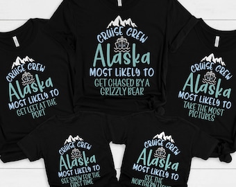 May include: Set of five black t-shirts with a white mountain graphic and blue text. The text reads "Cruise Crew Alaska" and includes a phrase about what you are most likely to do on a cruise to Alaska.