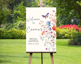 May include: Welcome to Carrie's Bridal Shower sign with a watercolor floral design featuring a butterfly and the date April 19, 2025.