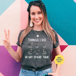 May include: Dark heather grey t-shirt with a graphic of raccoons and the text "THINGS I DO IN MY SPARE TIME".