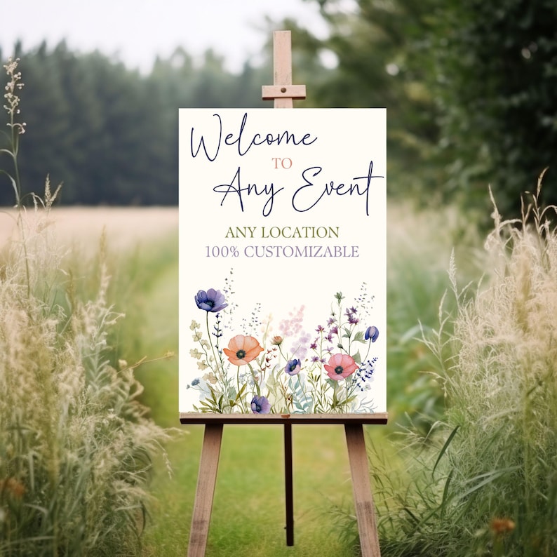 May include: Welcome to Any Event sign with a watercolor floral design. The sign is on a wooden easel and is 100% customizable. The text on the sign is in a purple and pink font.
