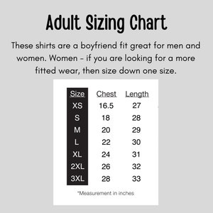 May include: A sizing chart for adult shirts with measurements in inches for chest and length. The chart includes sizes XS, S, M, L, XL, 2XL, and 3XL. The text states that the shirts are a boyfriend fit and that women should size down one size.