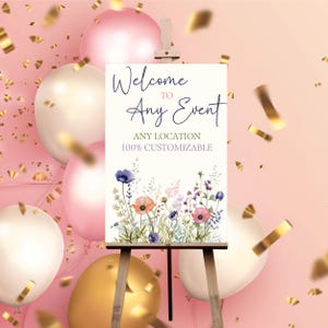 Puede incluir: Se&ntilde;al de bienvenida a cualquier evento con un dise&ntilde;o floral con flores rosas, moradas y azules sobre un fondo blanco. La se&ntilde;al est&aacute; en un caballete y es 100% personalizable.