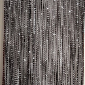Dark curtain with silver thread beaded curtain