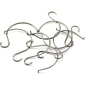 May include: A set of silver metal hooks, perfect for hanging items on a wall or in a closet.