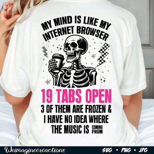 May include: White t-shirt featuring a black and white illustration of a skeleton holding a cup of coffee. The text on the shirt reads "My mind is like my internet browser 19 tabs open 3 of them are frozen & I have no idea where the music is coming from."