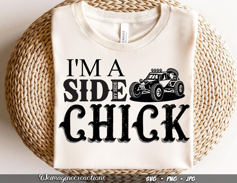 May include: White t-shirt with black text that reads "I'm a Side by Side Chick" and a black and white illustration of a side-by-side vehicle.