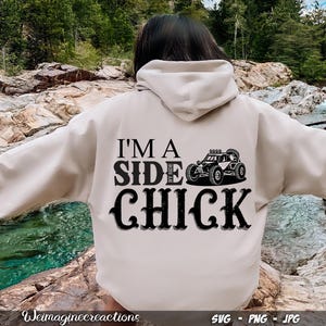 May include: A white hoodie with the text "I'm a Side Chick" in black lettering. A black and white illustration of a side-by-side vehicle is above the text.