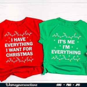 May include: Two Christmas themed t-shirts. One red t-shirt with the text "I have everything I want for Christmas" and a string of Christmas lights. The other green t-shirt with the text "It's me I'm everything" and a string of Christmas lights.