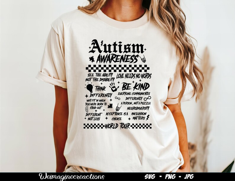 May include: A white t-shirt with a black graphic design that says "Autism Awareness" and includes a list of phrases about acceptance and neurodiversity. The graphic design is in a grunge style with a checkered border.