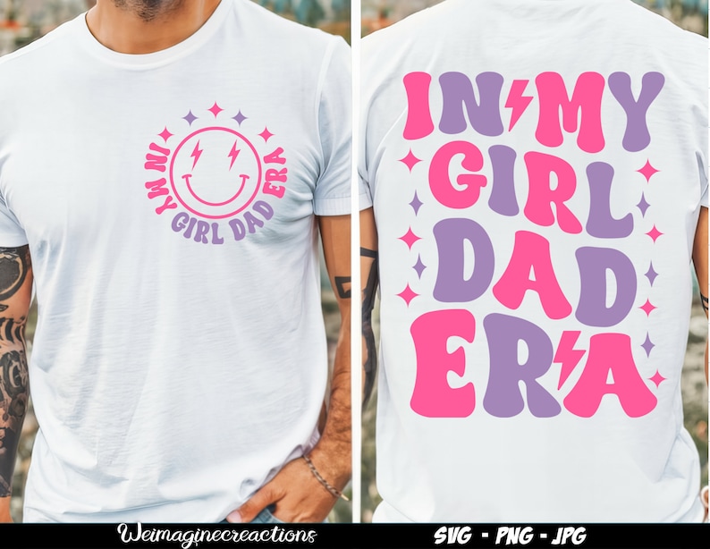 May include: White t-shirt featuring a pink and purple graphic that reads "In My Girl Dad Era" with a lightning bolt. The graphic is in a retro style font.